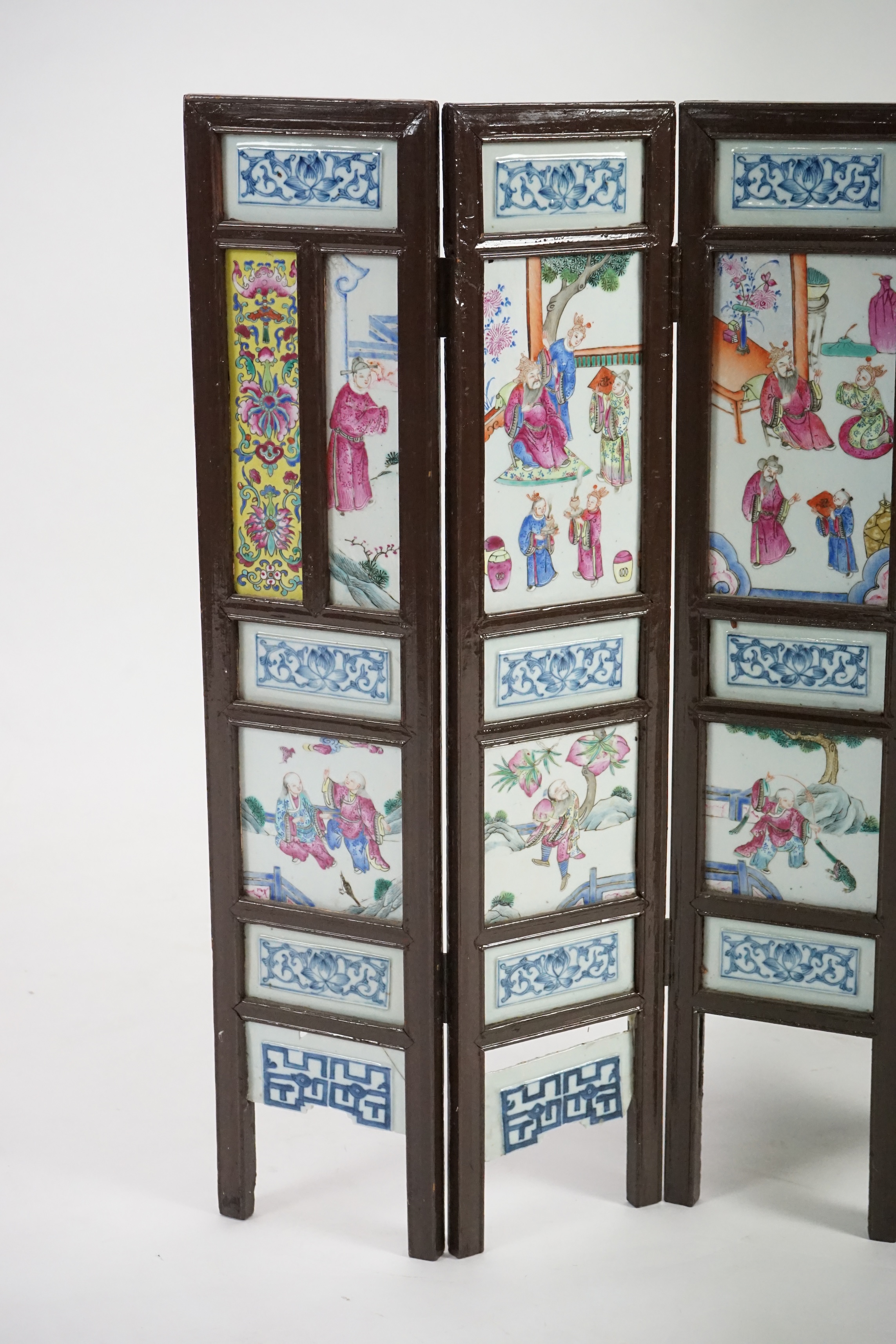 A Chinese wood framed and porcelain mounted low screen, late 19th century